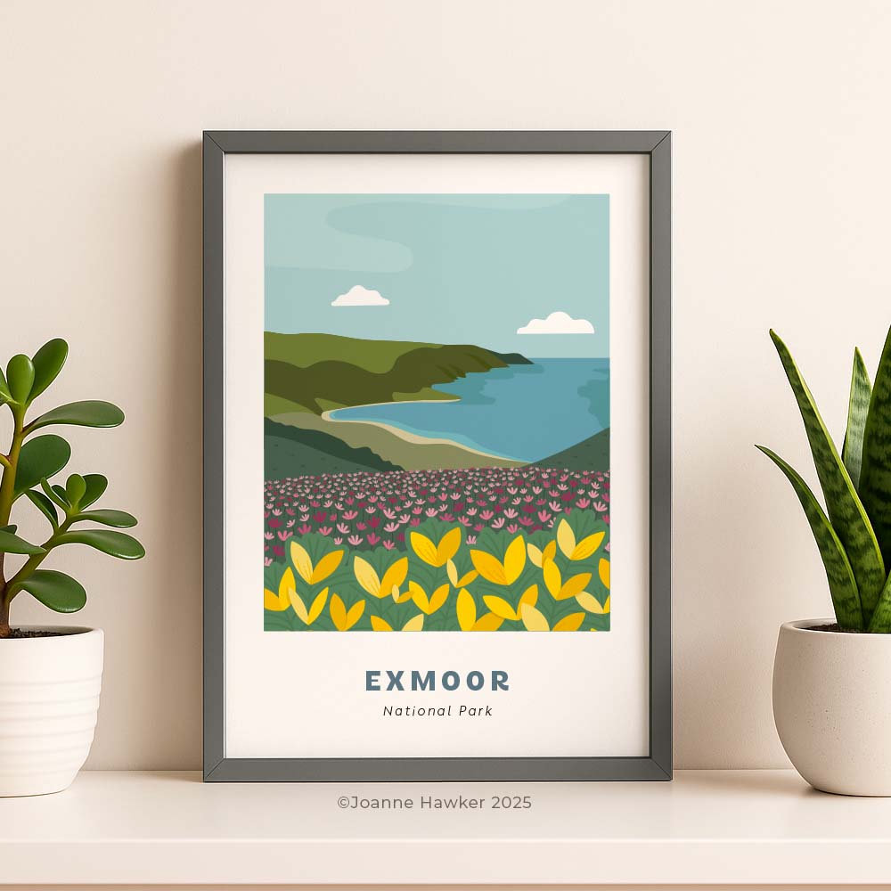 An A4 Exmoor national park print in a grey frame. The print shows a view from the hills of Exmoor over looking the Bristol channel with gorse and heather in the foreground moving into cliffs and the coastline.