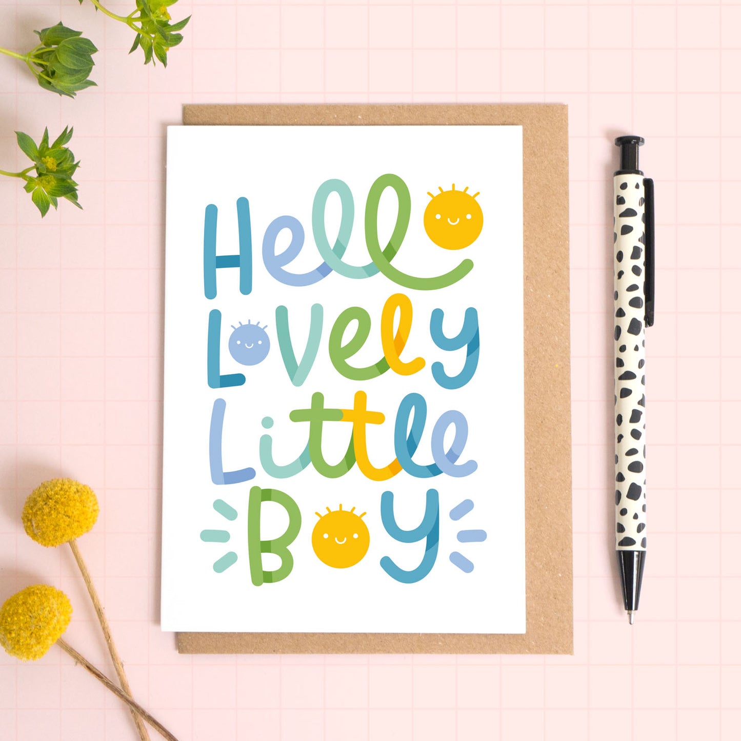 A new baby boy greeting card with 'Hello Lovely Little Boy' text on a pink background with a pen and flowers.