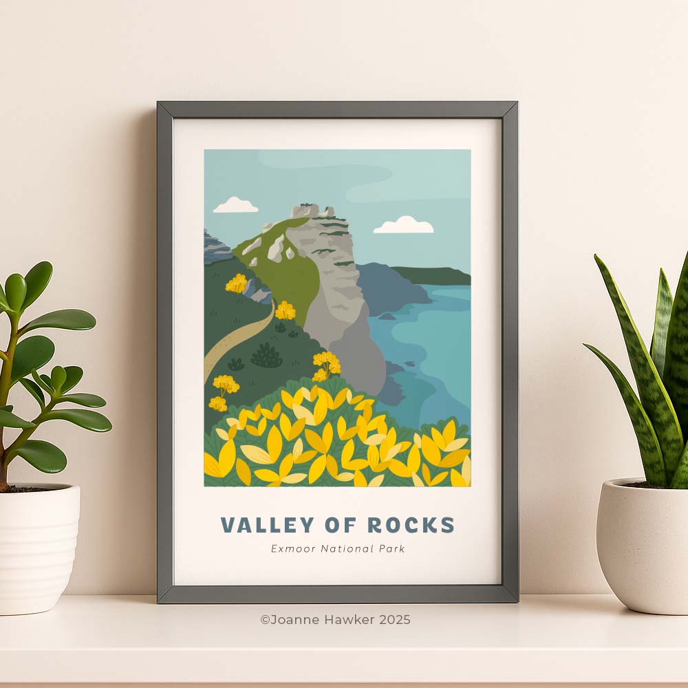 Framed, illustrated A4 print of Valley of Rocks in Exmoor National Park standing on a sideboard with plants.