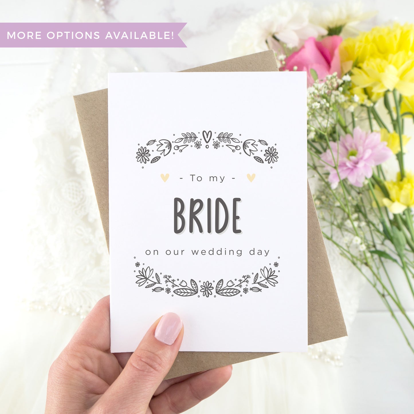 To my bride on our wedding day. A white card with grey hand drawn lettering, and a grey floral border. The image features a wedding dress and bouquet of flowers.