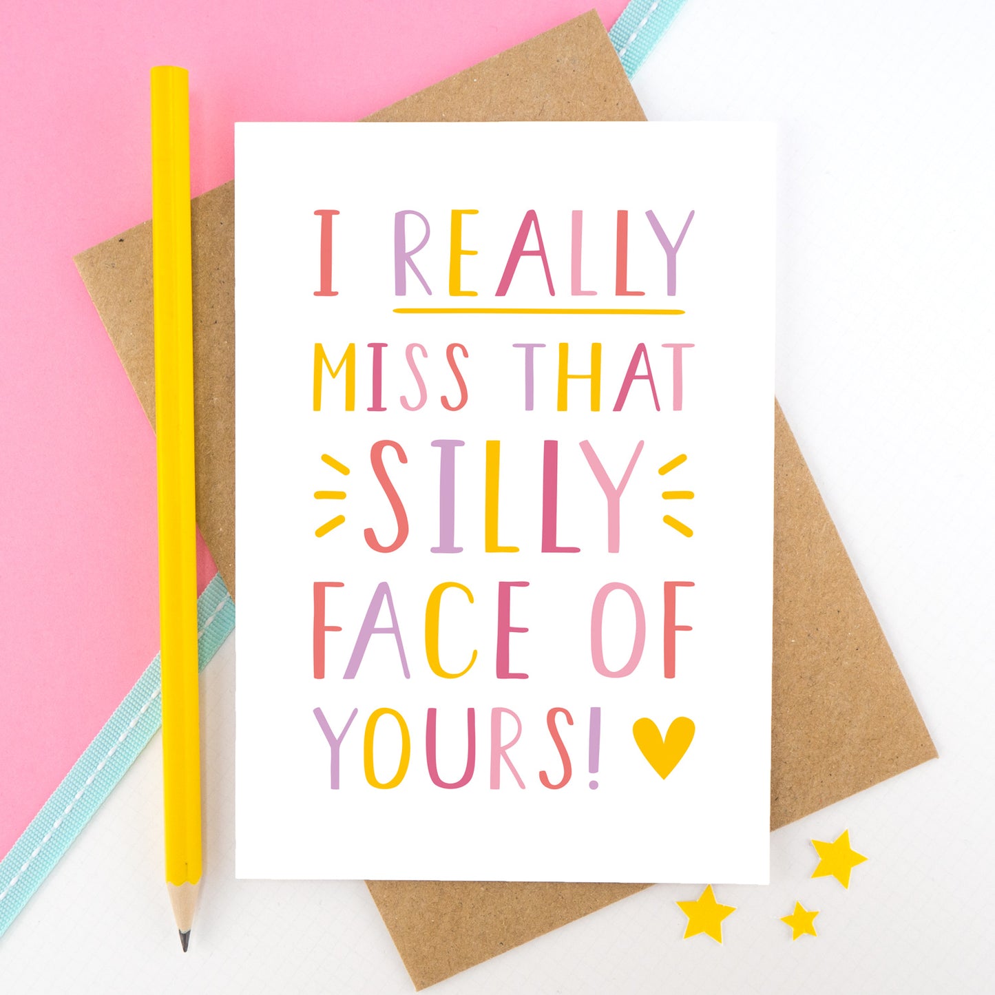 I really miss that silly face of yours card in pink, yellow and lilac shot on a pink background with a yellow pencil.