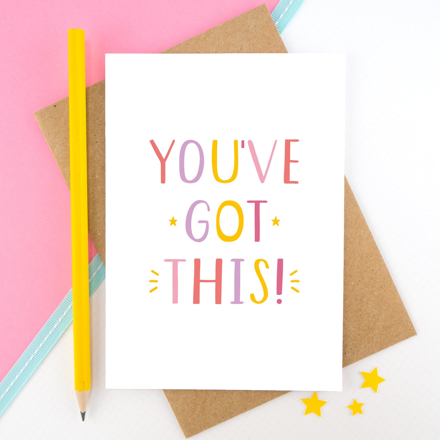 You've got this! A positive encouragement card photographed on a pink and white background with a teal ribbon and bright yellow pencil. The lettering on this card is in pinks, yellow and lilac.