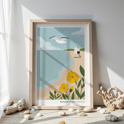 A coastal art print of the Low Lighthouse at Burnham-on-Sea inside of a wooden picture frame amongst driftwood and pebbles on a white background.