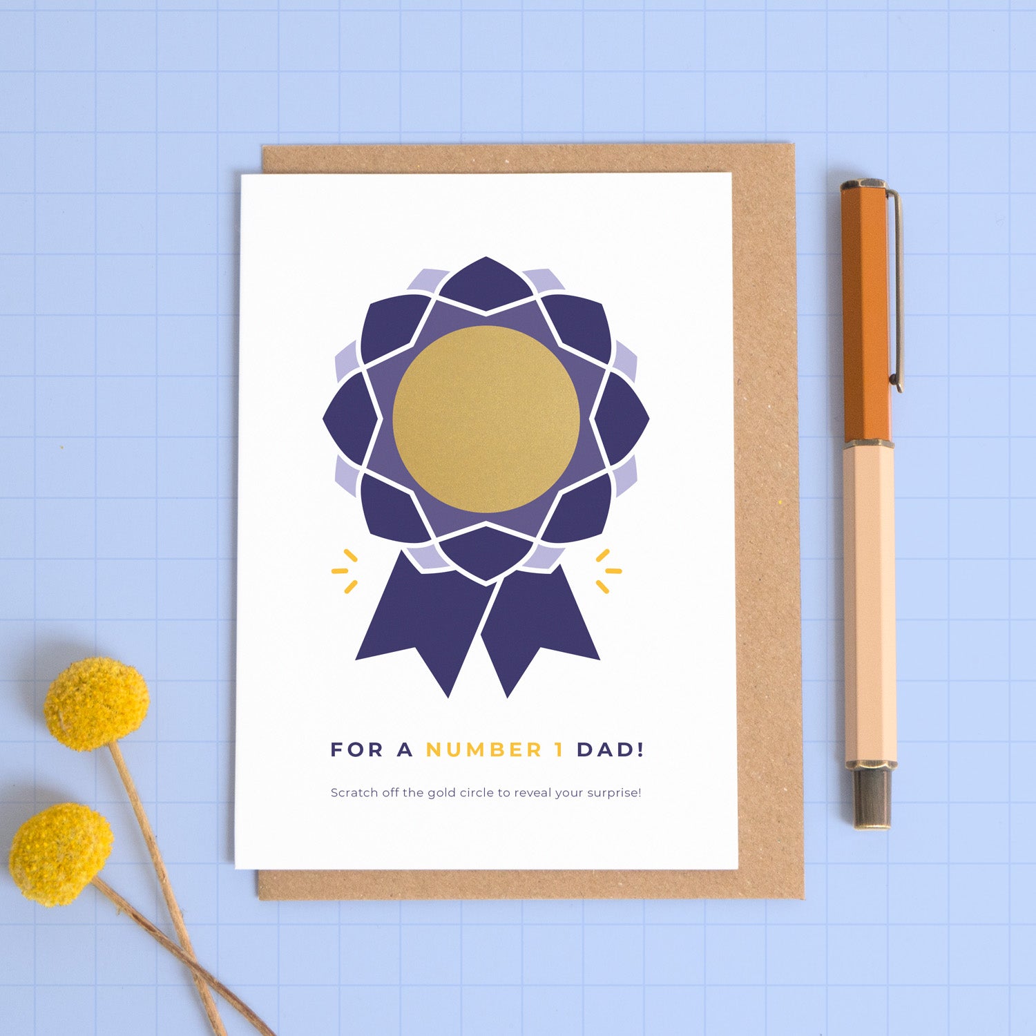 A number 1 dad scratch card featuring a rosette with a scratch off centre where your personalised message will be hidden. This card is showing the navy colour palette and how the card arrives with the gold circle intact.