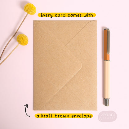 This image is all about the envelope that is included with every card! This image shows that envelope and has text that reads “every card comes with a Kraft brown envelope” and has been photographed on a pink background.