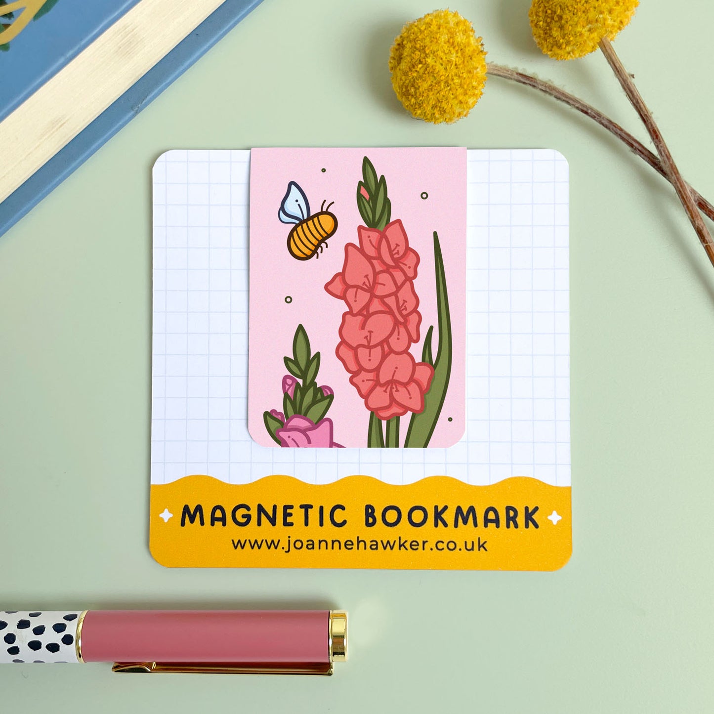 Magnetic bookmark with floral gladiolus design and bee illustration on a light green background