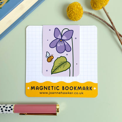 Magnetic bookmark with floral violet design on a light green background