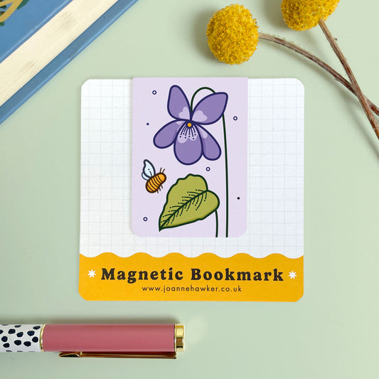 Magnetic bookmark with floral violet design on a light green background