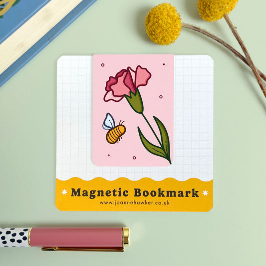 Magnetic bookmark with a floral carnation design and brand information on a light green background