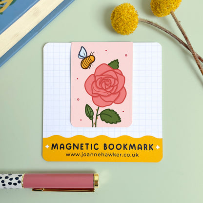Magnetic bookmark with a rose and bee design on a light green background