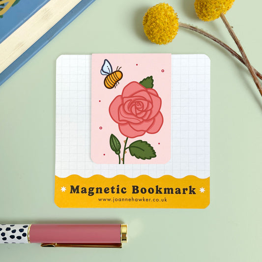 Magnetic bookmark with a rose and bee design on a light green 