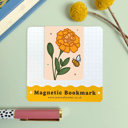 Magnetic bookmark with floral marigold design and bee illustration on a light green background
