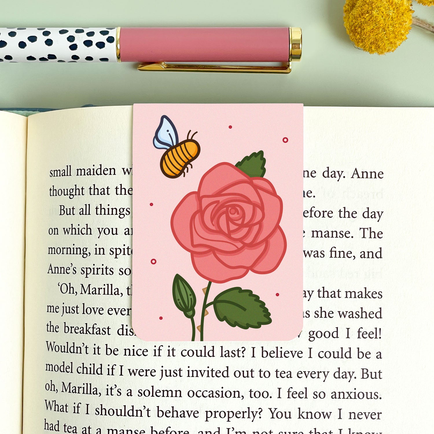 Bookmark with a pink rose and a bee illustration on a green background