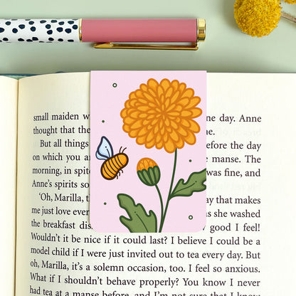 Floral chrysanthemum bookmark with a bee design on an open book