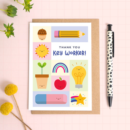 Thank you key worker card with a kraft brown envelope. This key worker thank you card features a variety of happy school related objects including an acorn, pencil, growing seed, apple and an eraser. The perfect card for nursery staff!