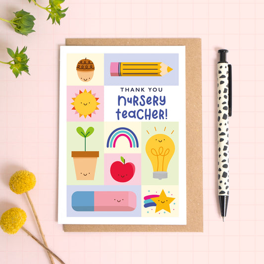 Thank you nursery teacher card with a kraft brown envelope. This nursery teacher thank you card features a variety of happy school related objects including an acorn, pencil, growing seed, apple and an eraser. The perfect card for nursery staff!