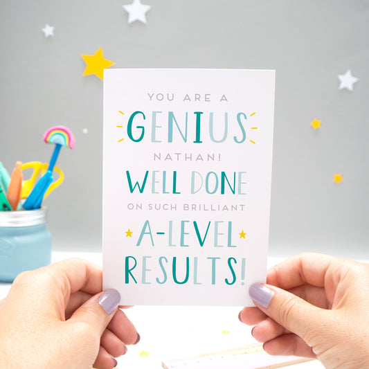 'You are a genius [insert name]! Well done on such brilliant A-Level results'. A personalised exam congratulations card featuring my hand drawn letters in varying shades of blue, and with yellow stars.