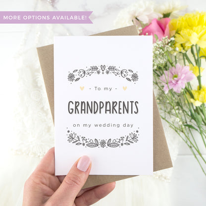 To my grandparents on my wedding day. A white card with grey hand drawn lettering, and a grey floral border. The image features a wedding dress and bouquet of flowers.