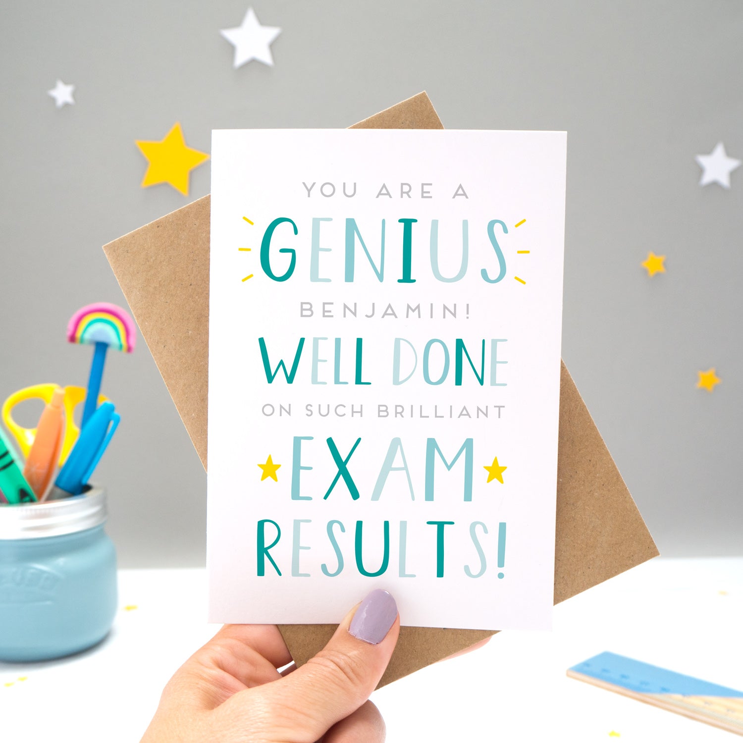 'You are a genius [insert name]! Well done on such brilliant exam results'. A personalised exam congratulations card featuring my hand drawn letters in varying shades of blue and yellow stars.