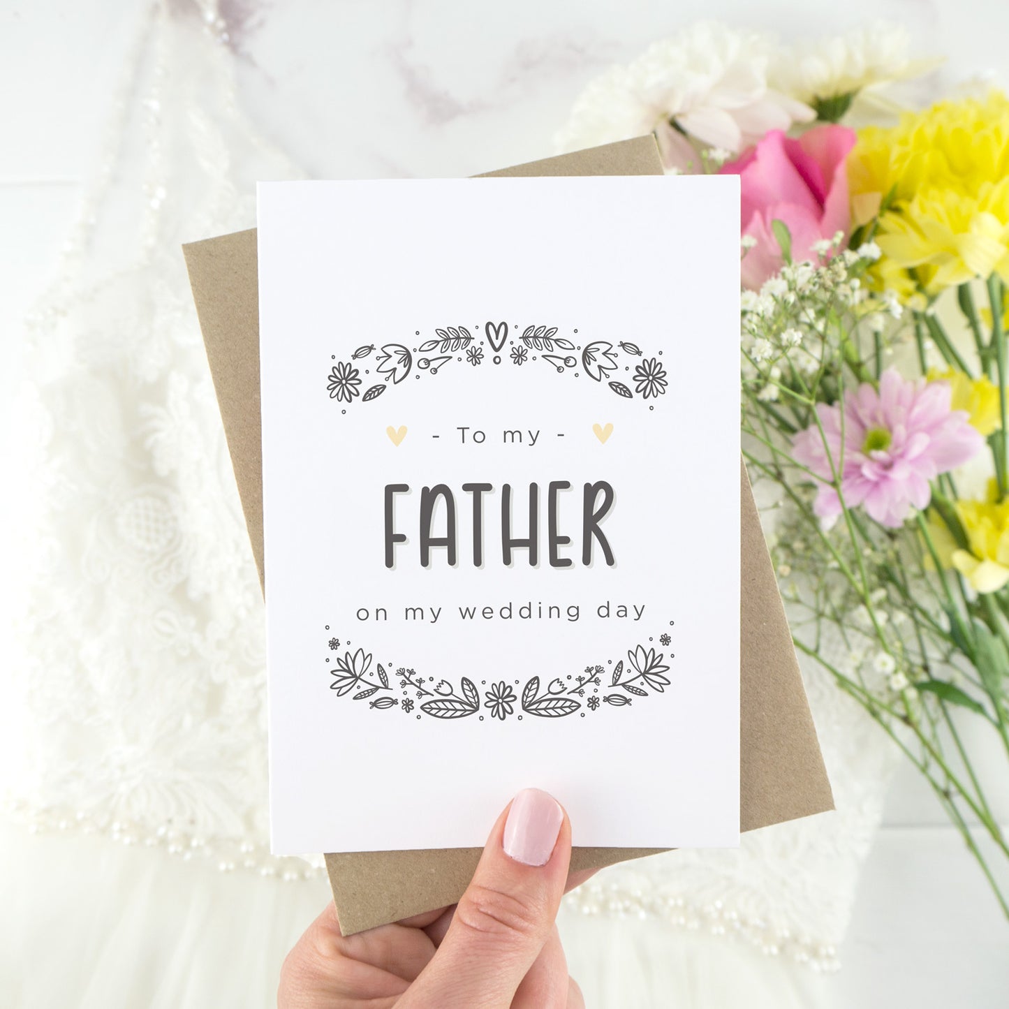 To my father on my wedding day. A white card with grey hand drawn lettering, and a grey floral border. The image features a wedding dress and bouquet of flowers.