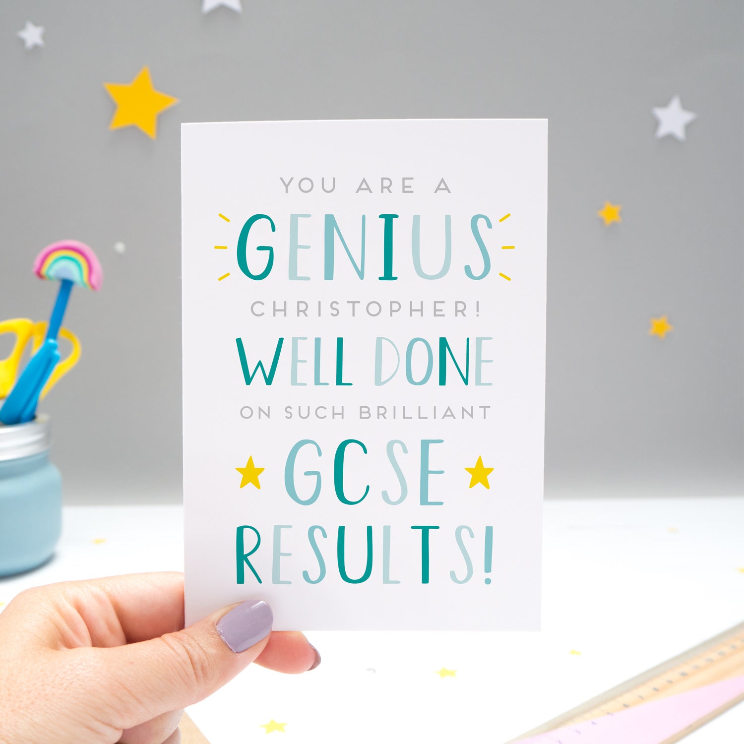 'You are a genius [insert name]! Well done on such brilliant GCSE results'. A personalised exam congratulations card featuring my hand drawn letters in varying shades of blue and yellow stars.