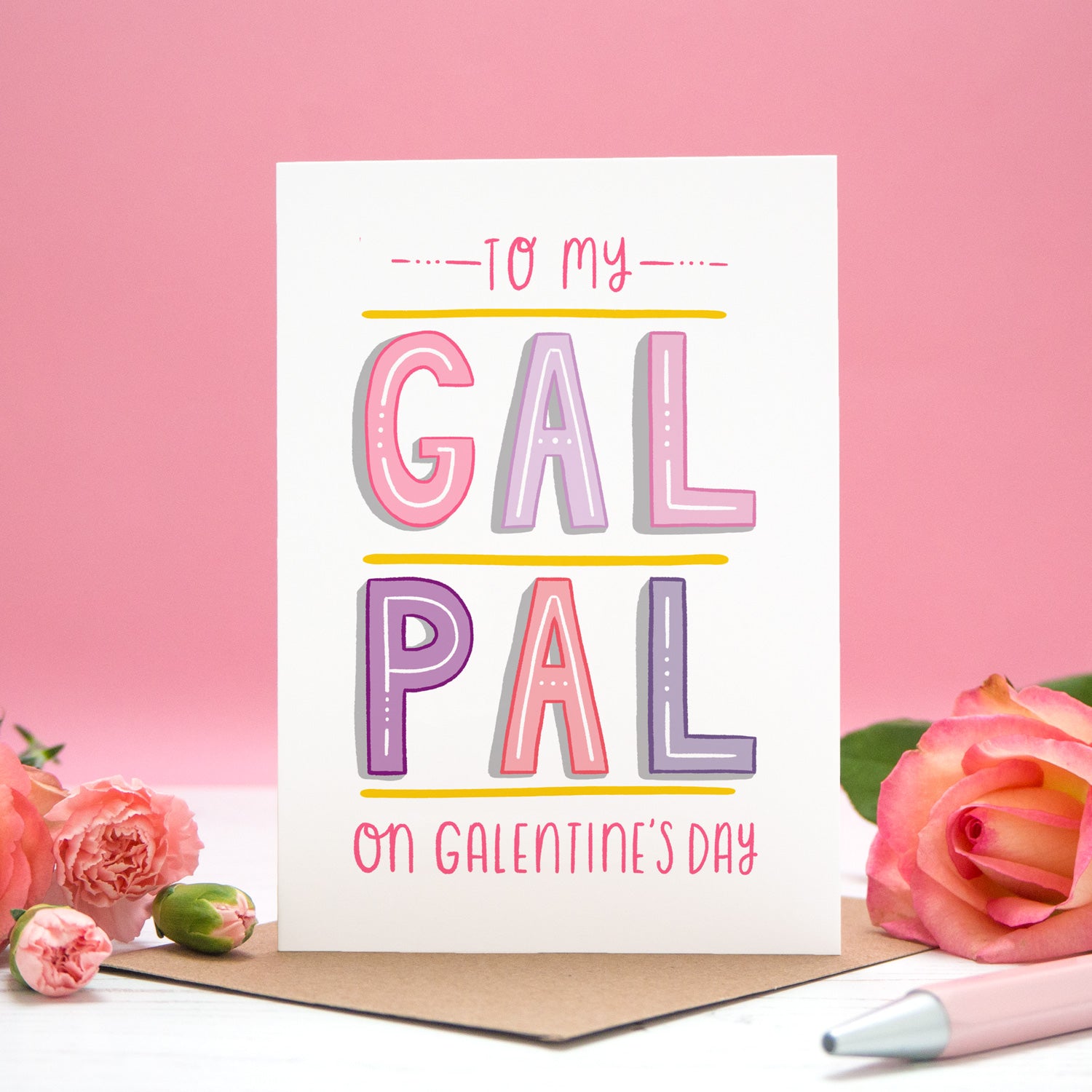 To my Gal Pal on Galentine's Day. A friendship card designed for Valentine's or Galentine's day! The image features my hand lettered card between two roses and on a pink background.