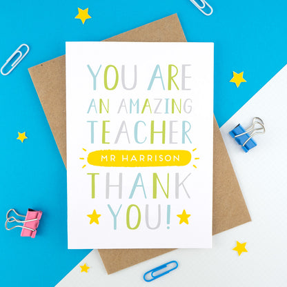 A personalised thank you teacher card that reads 'you are an amazing teacher [insert name of teacher] thank you! In green, blue, grey and a pop of yellow