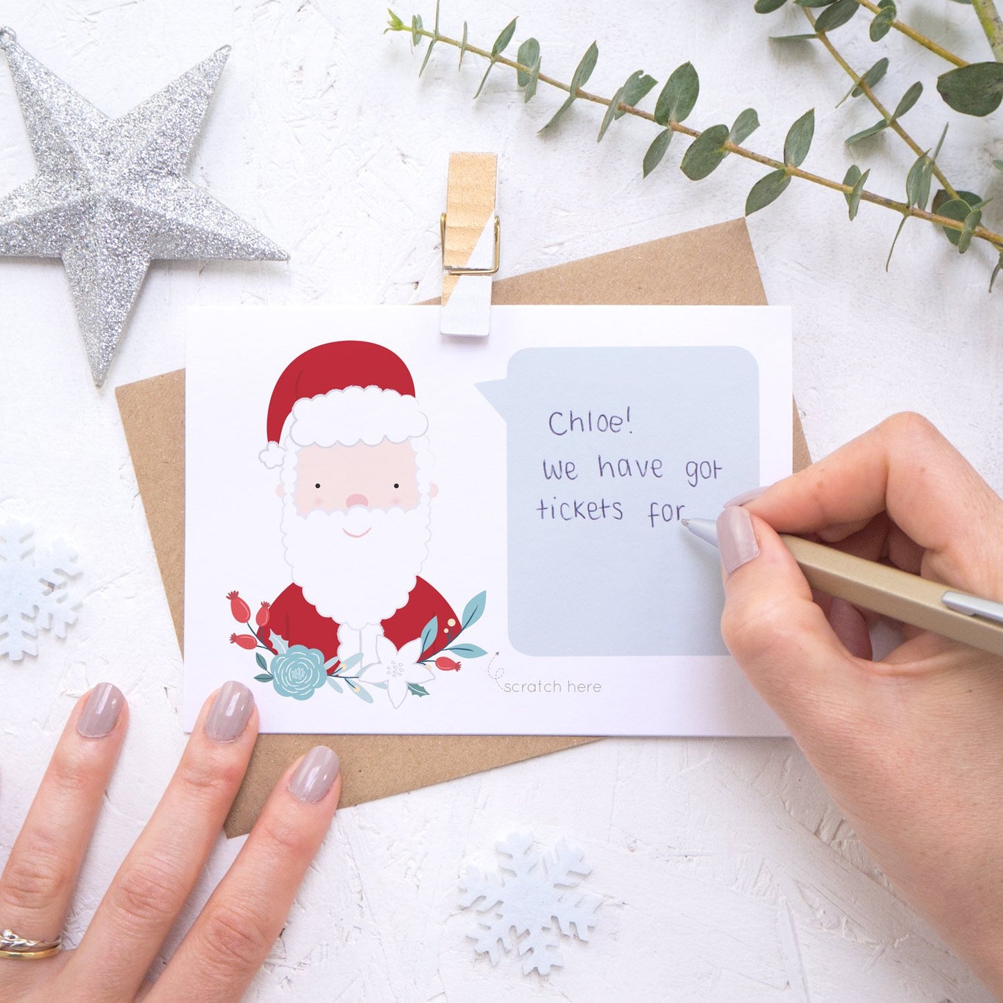 Personalised Santa secret message Christmas scratch card being hand written.