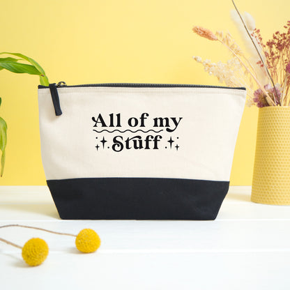 An 'all of my stuff' project bag shot on a white and yellow background with dry flowers in the foreground.
