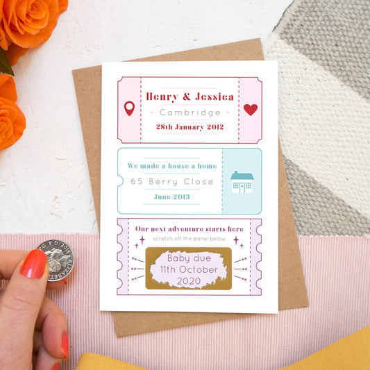 A personalised baby due date announcement card by Joanne Hawker featuring life special milestones before scratching to reveal baby due date!