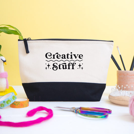 A creative stuff project bag shot on a white and yellow background with craft materials in the foreground.