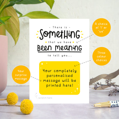 A personalised custom announcement scratch card photographed stood on a grey surface, a white textured background and with a pot plant on the left. Some small flowers and a pen are also in the foreground. This card is the black and yellow colour way. The orange circles show areas of the card that contain choices e.g. colour, wording and scratch message.