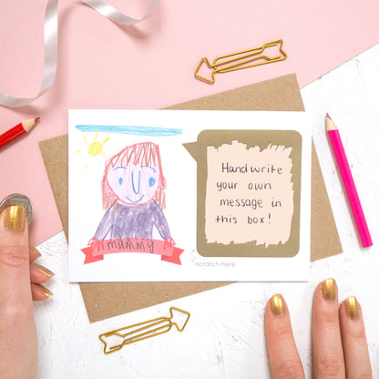 Draw your own scratch card with a hand written message of 'i love you mummy'. The card features a child like drawing of a person and the panel has been scratched off to reveal a hand written message.