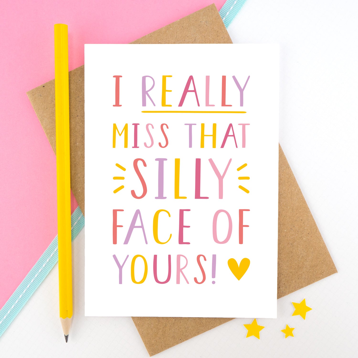 I really miss that silly face of yours card in pink, yellow and lilac shot on a pink background with a yellow pencil.