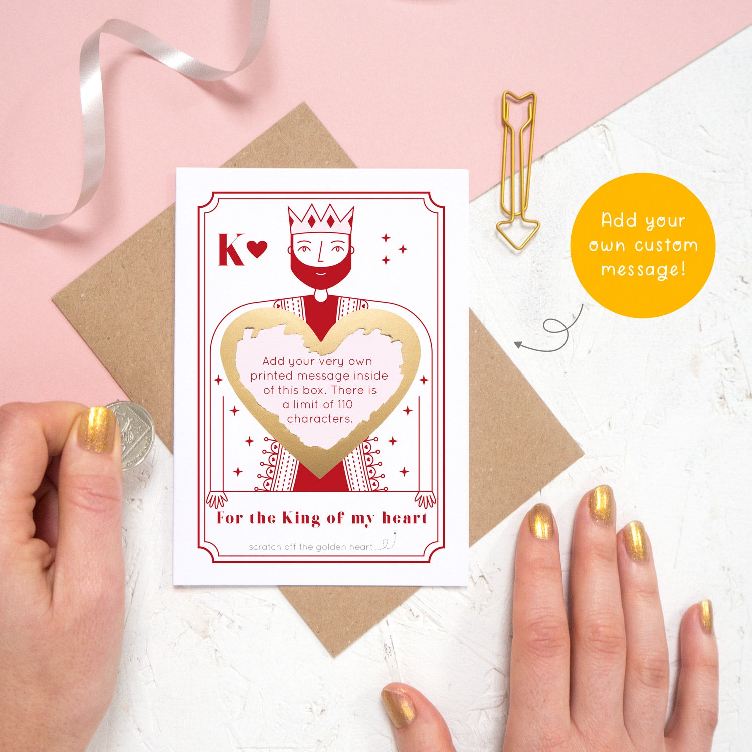 A custom king of hearts scratch card shot on a pink and white background with a scratched off heart with a custom message