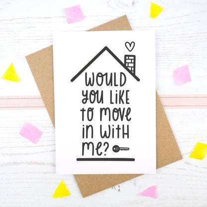 Would you like to move in with me card in black & white, under a roof with a chimney and heart.