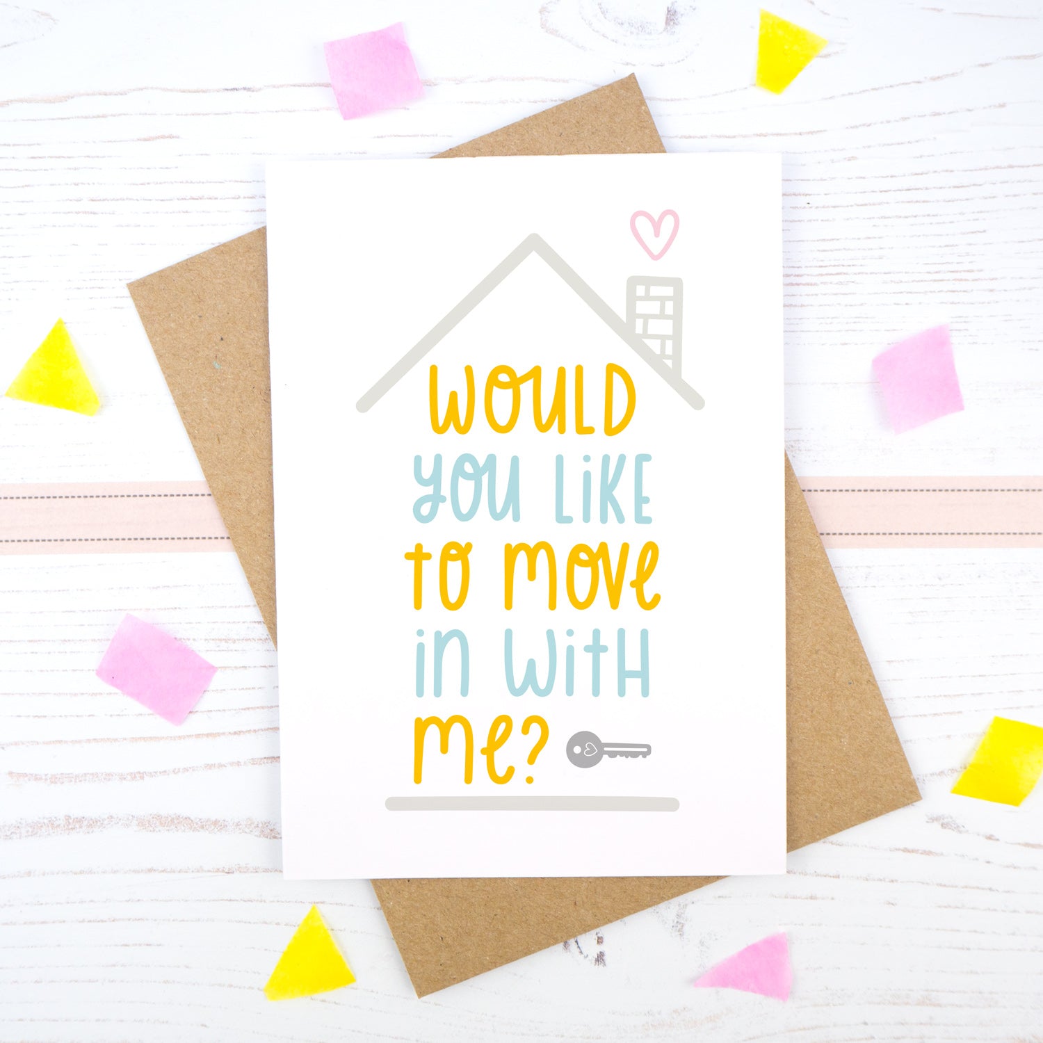 Would you like to move in with me card in blue and orange, under a grey roof and a dark grey key.