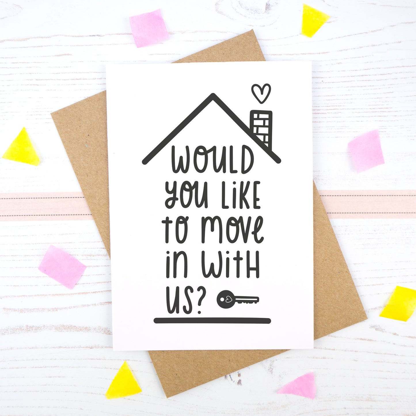 Would you like to move in with us card in black & white, under a roof with a chimney and heart.
