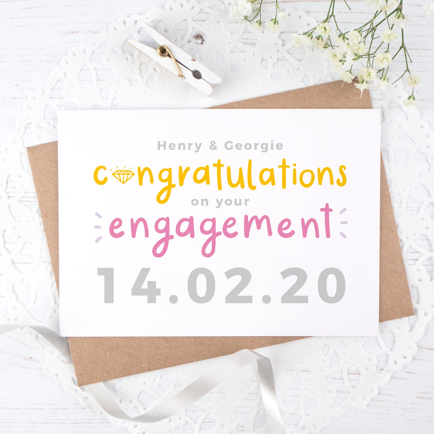 A personalised engagement card with room for the happy couples names and date the question was popped! This card has orange and pink text on a white background with a grey date.