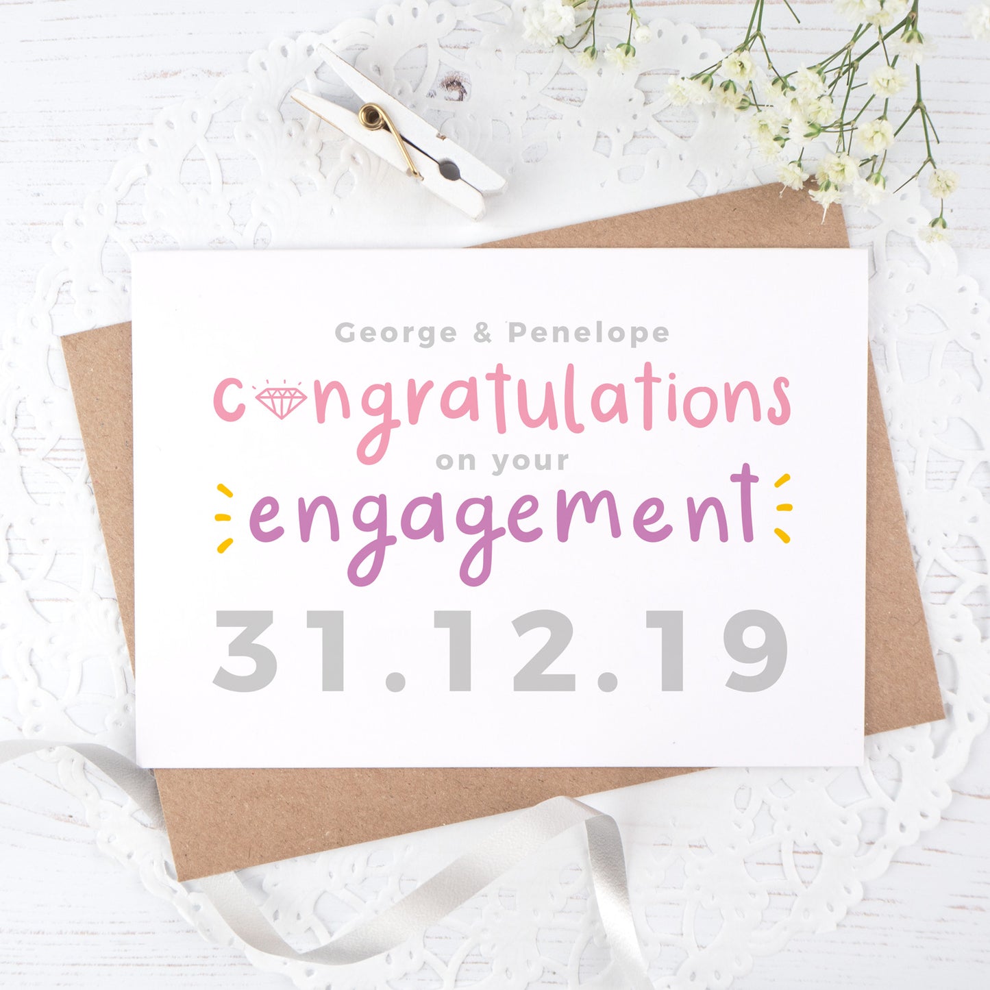 A personalised engagement card with room for the happy couples names and date the question was popped! This card has purple and pink text on a white background with a grey date.
