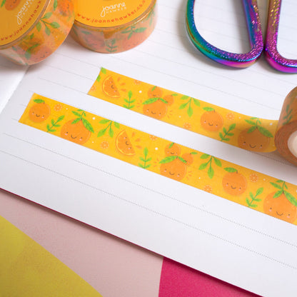 Strips of satsuma washi tape cut to size and stuck down in a white lined notebook.