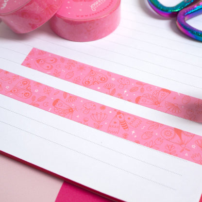 Strips of the pink moths washi tape cut to size and stuck down in a white lined notebook.
