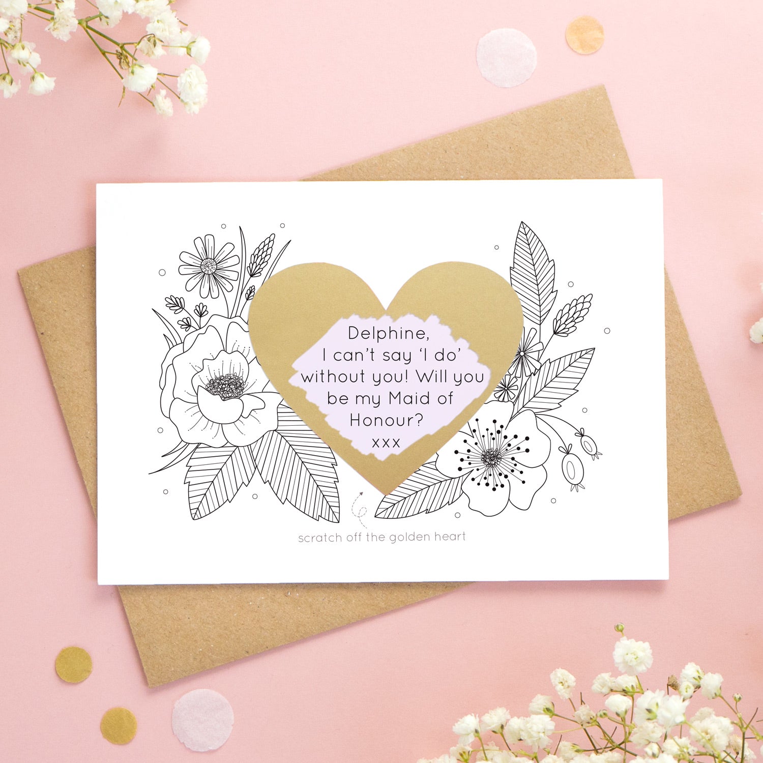 A personalised wedding scratch card shot on a pink background with white flowers. The golden heart has been scratched revealing a purple heart and a maid of honour proposal!