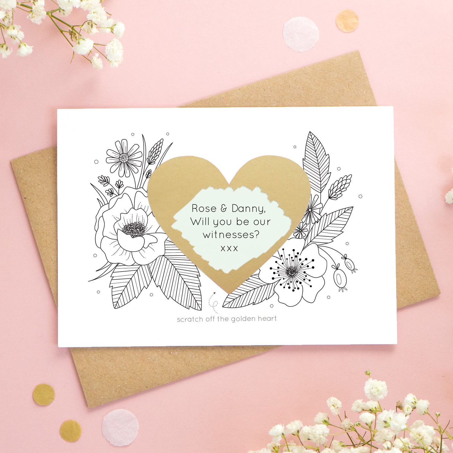 A personalised wedding scratch card shot on a pink background with white flowers. The golden heart has been scratched revealing a green heart and a witness proposal!
