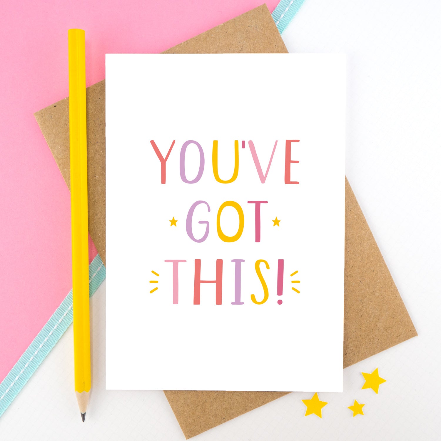 You've got this! A positive encouragement card photographed on a pink and white background with a teal ribbon and bright yellow pencil. The lettering on this card is in pinks, yellow and lilac.