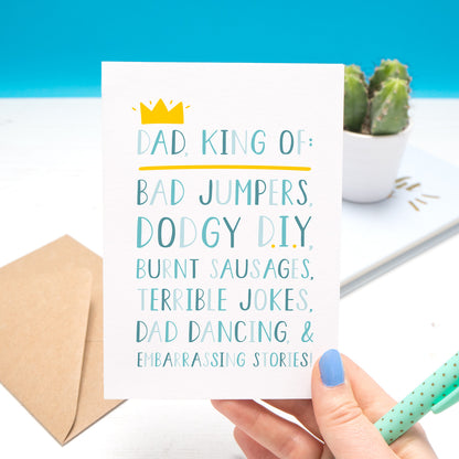 'Dad, king of: bad jumpers, dodgy d.i.y, burnt sausages, terrible jokes, dad dancing and embarrassing stories!' - Father's day card in blue with a little yellow crown.