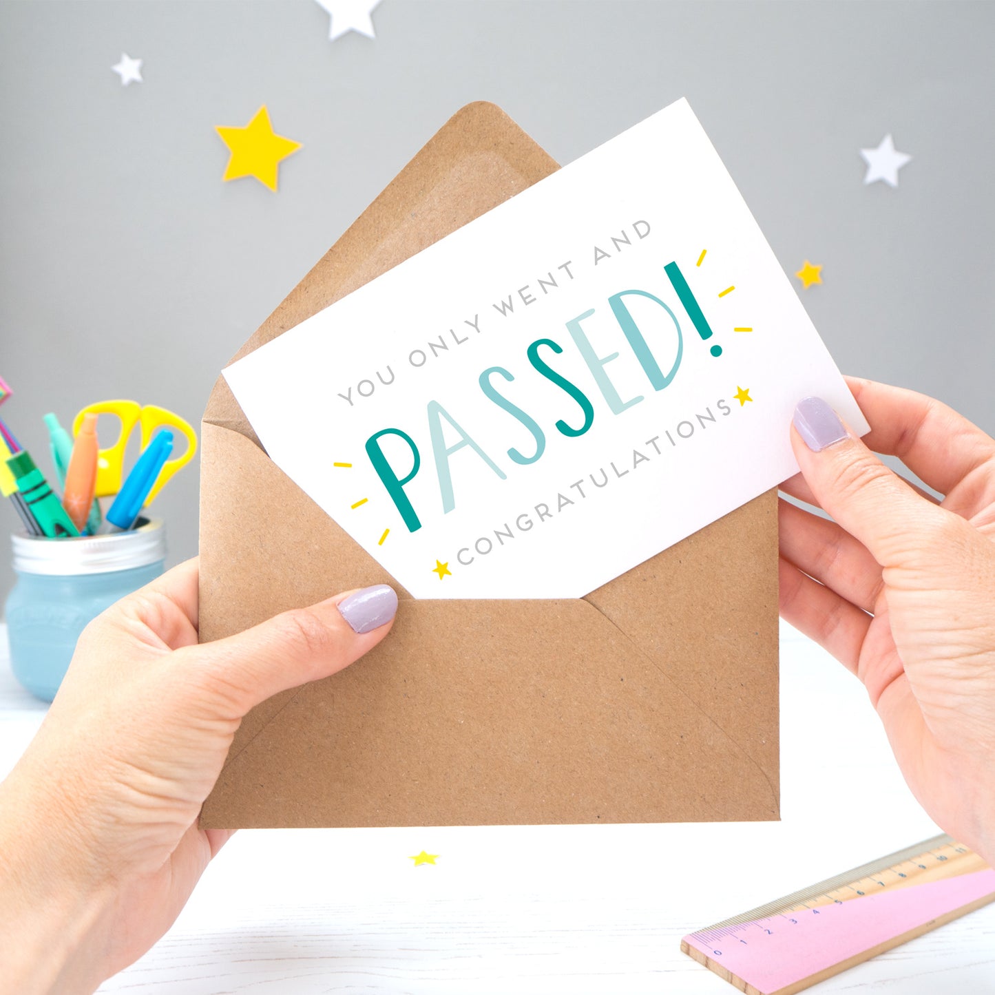 'You only went and passed! Congratulations!' A congratulations card for someone who has completed their exams recently. It features grey text with the word 'passed' in a hand lettered font with varying tones of blue and yellow stars.
