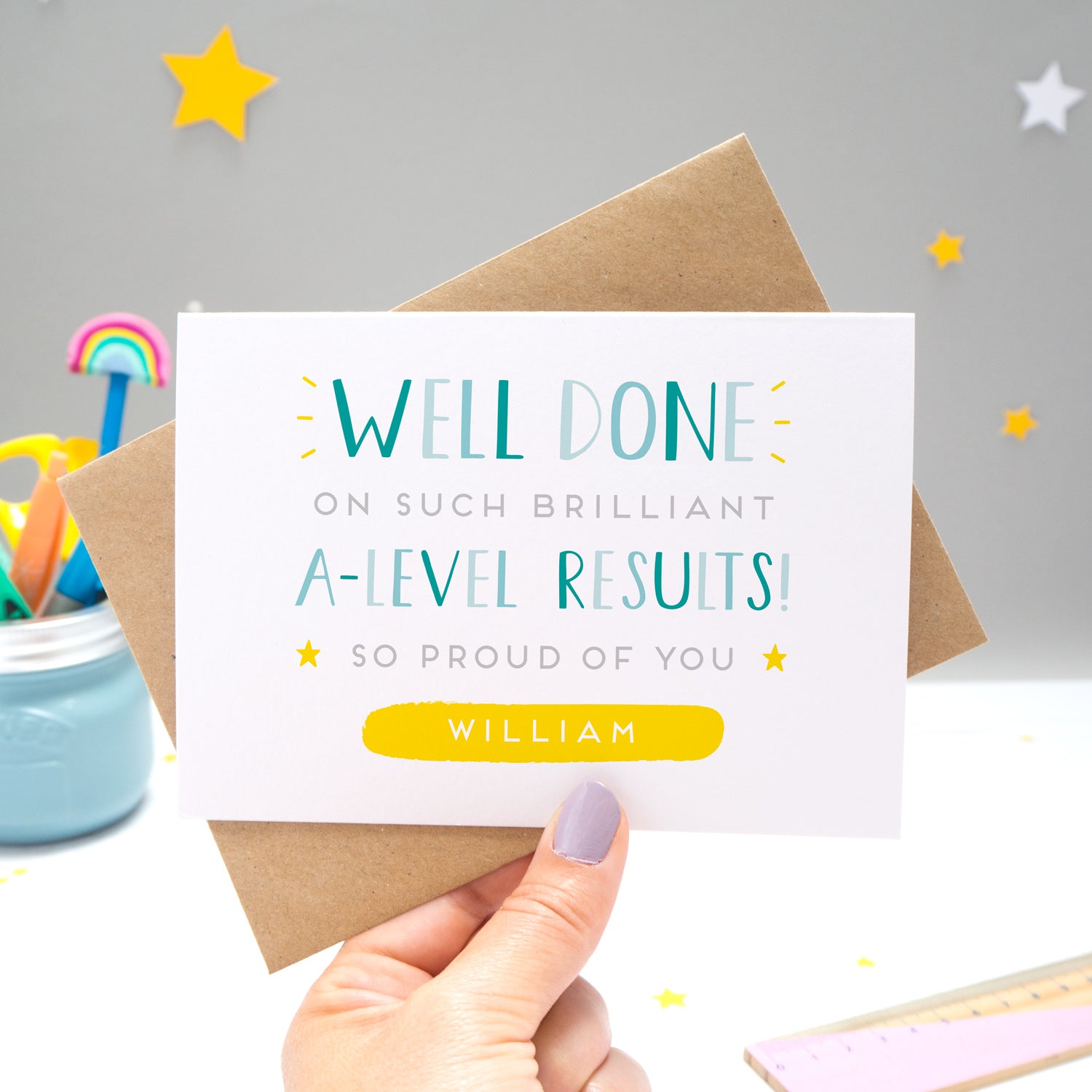 'Well done on such brilliant A-Level Results! So proud of you [insert name].' A congratulations card featuring my hand drawn type in varying shades of blue, with a bright yellow personalised box for the recipient name!