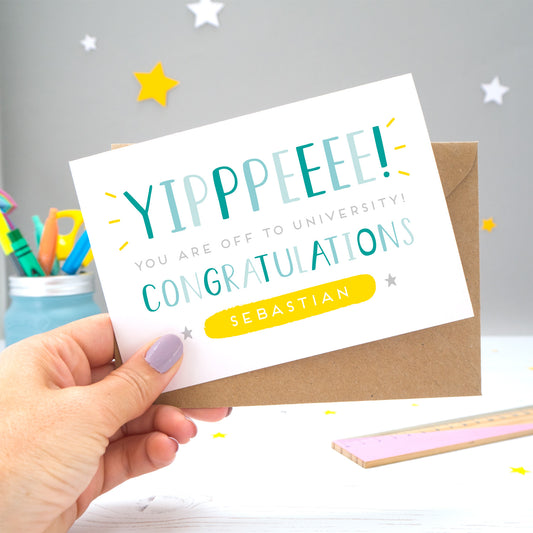 'Yipppeeee! You are off to university, congratulations! A personalised university exams congratulation card with alternative shades of blue over a hand lettered font, small grey stars and a yellow name box.