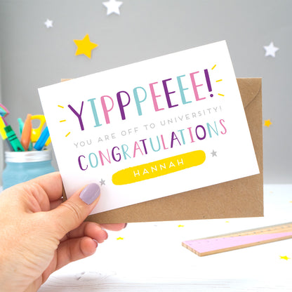 'Yipppeeee! You are off to university, congratulations! A personalised university exams congratulation card with alternative shades of blue, purple and pink, over a hand lettered font, small grey stars and a yellow name box.